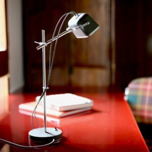 selective focus photo of gray and white articulated table lamp